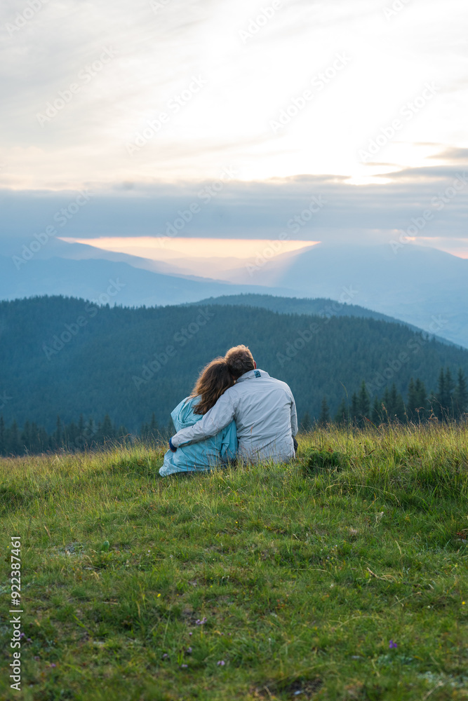 couple a man and a woman sit together bowing their heads on their shoulders and looking into the distance at a beautiful view support, support, partnership, common difficulties, relationships, family couple a man and a woman sit together bowing their heads on their shoulders and looking into the distance at a beautiful view support, support, partnership, common difficulties, relationships, family