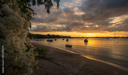 Boats float in the Indian Ocean at sunset in Grand Baie, Mauritius, Africa.