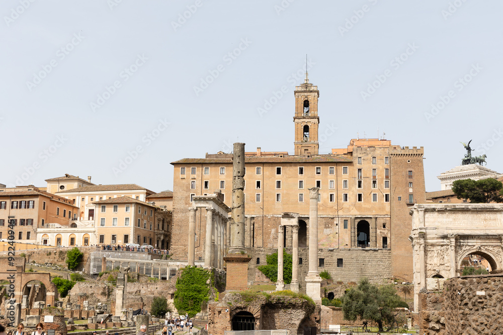 Rome, Italy - April 09, 2024: Ruins of the Roman Forum with tourists strolling among the archaeological remains in Rome, Italy Rome, Italy - April 09, 2024: Ruins of the Roman Forum with tourists strolling among the archaeological remains in Rome, Italy