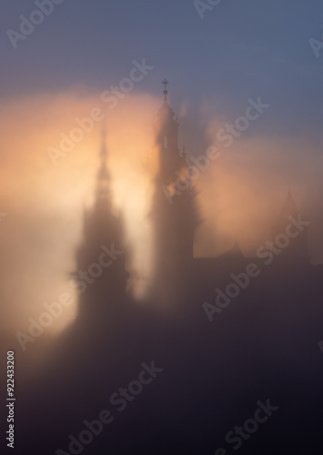 Krakow, Poland, Wawel cathedral towers shrouded in the fog, sunlit in the morning photo