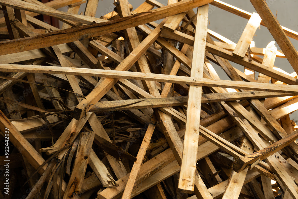A pile of wood is scattered on the ground. The wood is in various sizes and shapes, and it is a mess. Scene is chaotic and disorganized A pile of wood is scattered on the ground. The wood is in various sizes and shapes, and it is a mess. Scene is chaotic and disorganized