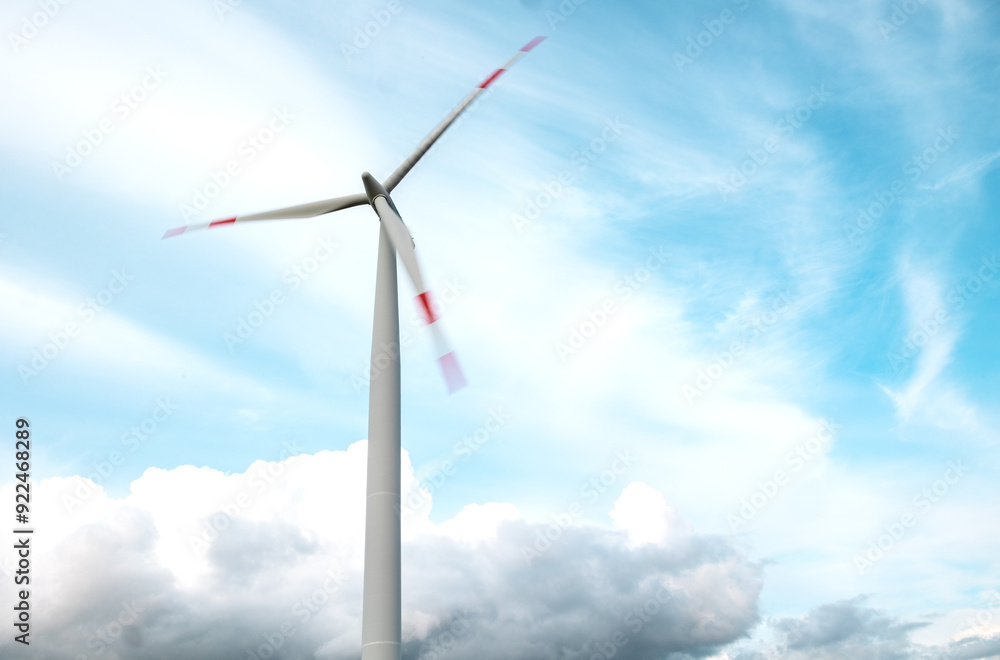 Wind turbine with rotating blades, clouds in the background. The ends of the blades are blurred. Wind turbine with rotating blades, clouds in the background. The ends of the blades are blurred.
