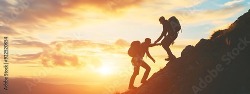 A person helping another up to the top of the mountain, demonstrating friendship and assistance in climbing