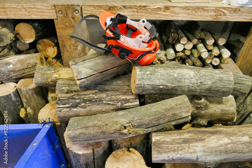 Sawn logs stacked in a workshop ready for splitting with a hydraulic log splitter
 photo