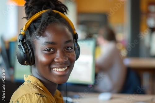 Portrait of a smiling young black female IT support worker in startup company office