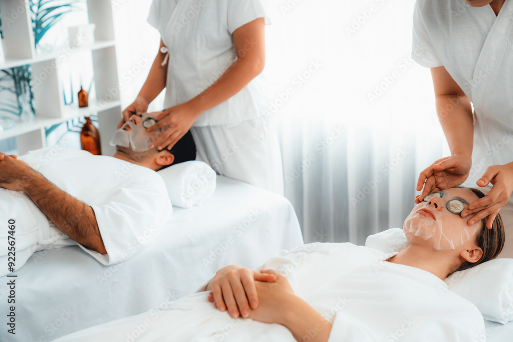 Obraz premium Serene daylight ambiance of spa salon, couple customer indulges in rejuvenating with luxurious cucumber facial mask. Facial skincare treatment and beauty care concept. Quiescent