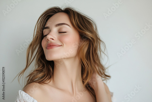 A close up of a woman's face with her eyes closed