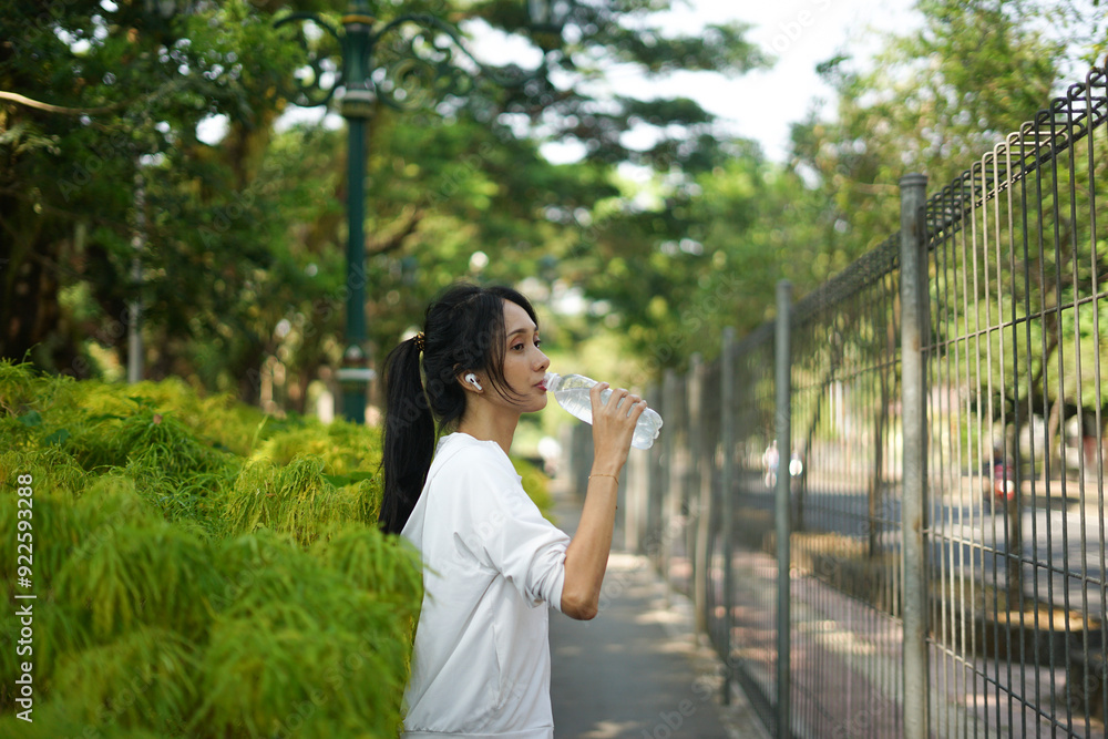 beautiful woman drinking water from bottle after exercise beautiful woman drinking water from bottle after exercise