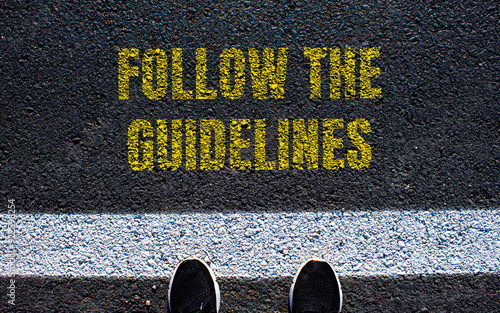 Schilderij op canvas Follow the guidelines message written on asphalt road
