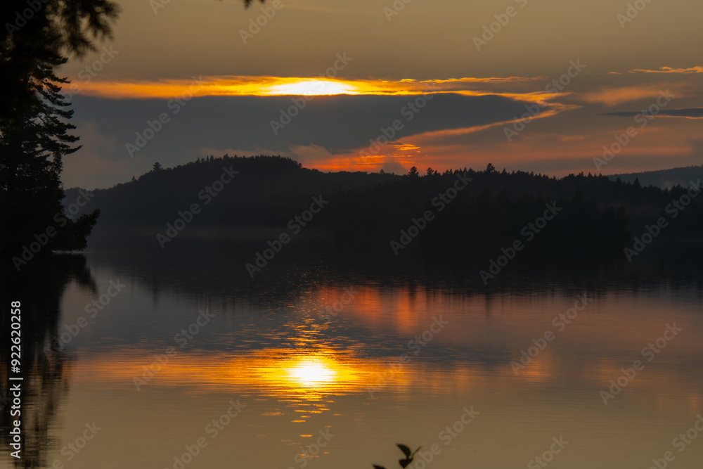 Fototapeta premium Sunset over a magnificent fishing lake in the Canadian forest