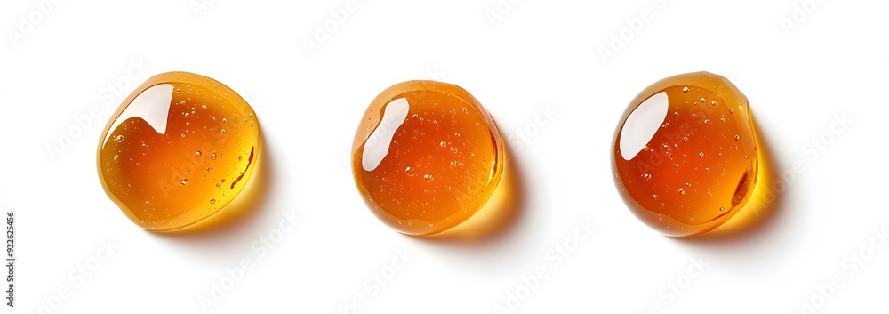 Fototapeta premium Three Drops of Honey on a White Background.