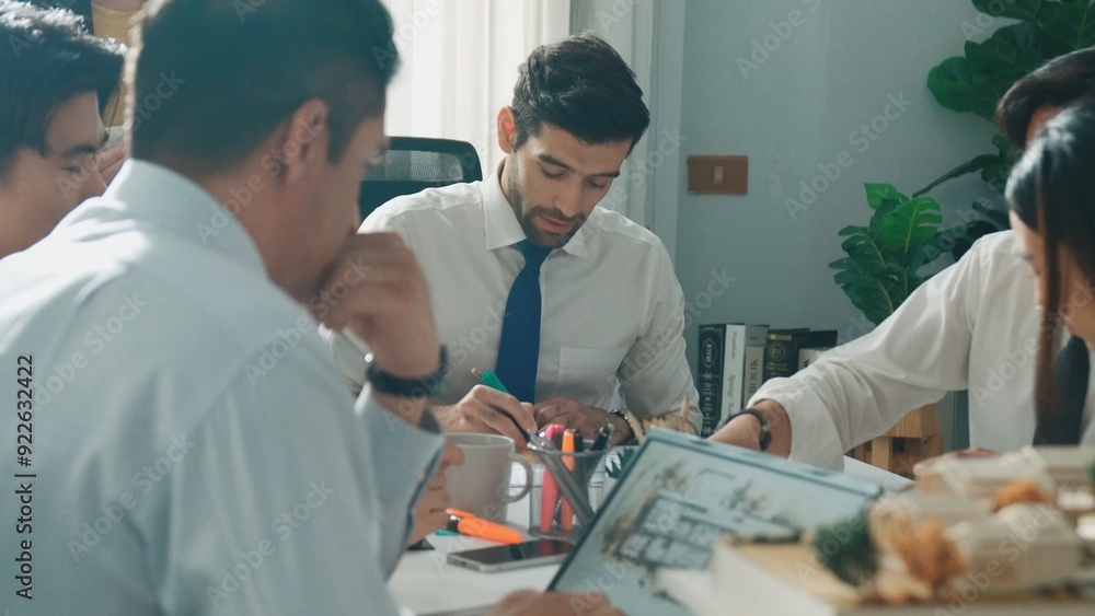 Obraz premium Top aerial view of project manager or civil engineer writing at blueprint and planning building design. Aerial view of architect working together at meeting table with document placed. Alimentation.