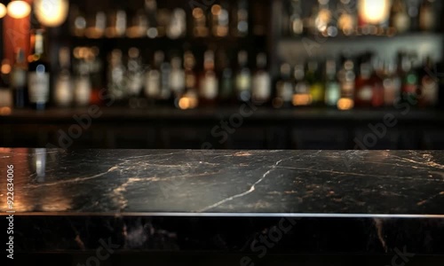 Black marble bar counter top with blank space product mockup. on dark blurred background of restaurant or bar