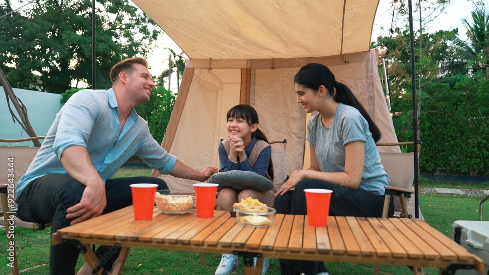 Family all together sit at camp in garden with tasty snack. Lovely parent use outdoor camping activity as way to communicate and spending time with young generation cross generation gap. Divergence. Family all together sit at camp in garden with tasty snack. Lovely parent use outdoor camping activity as way to communicate and spending time with young generation cross generation gap. Divergence.