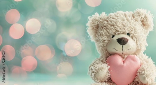 Adorable Teddy Bear Holding Pink Heart Against Soft Blue Background
