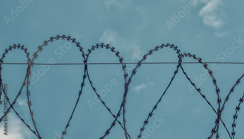 Konstfotografi barbed wire on blue sky background