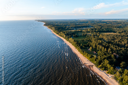 Wallpaper Mural A long stretch of the Baltic Sea coastline in Latvia, where the sandy beach meets calm blue waters under a clear sky Torontodigital.ca