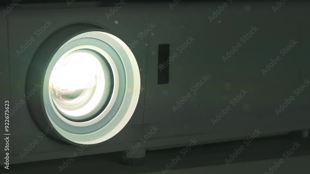 Slow Motion Working movie projector. Dust in cinema hall is visible in ray of light. Projector in operation