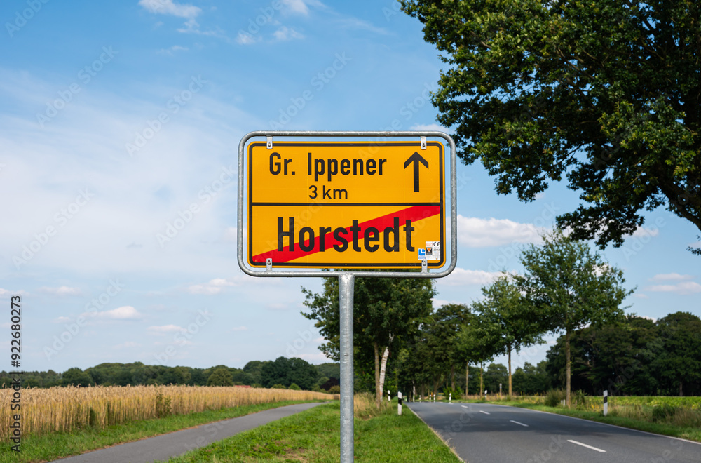 Horstedt, Lower Saxony, Germany, July 15, 2024 - Yellow sign of the village with a natural background Horstedt, Lower Saxony, Germany, July 15, 2024 - Yellow sign of the village with a natural background