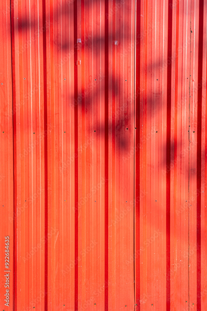 Red or orange old corrugated metal with Shadow of a branch texture surface sheet for industrial building background, copy space text or design Red or orange old corrugated metal with Shadow of a branch texture surface sheet for industrial building background, copy space text or design