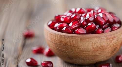 Fresh Pomegranate Seeds in a Bowl on Wooden Table