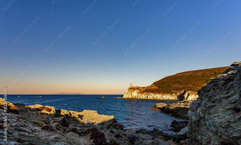 Genoese Agnello tower at sunset, Barcaggio, Cap Corse, Corsica, France. Capraia Isola, Italian island, in background. Genoese Agnello tower at sunset, Barcaggio, Cap Corse, Corsica, France. Capraia Isola, Italian island, in background.