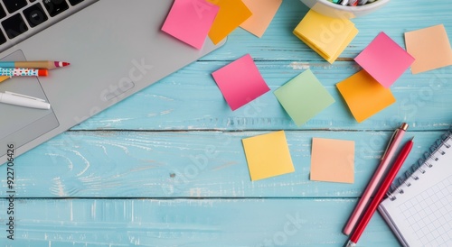 Workspace With Sticky Notes and Stationery on a Light Blue Wooden Table