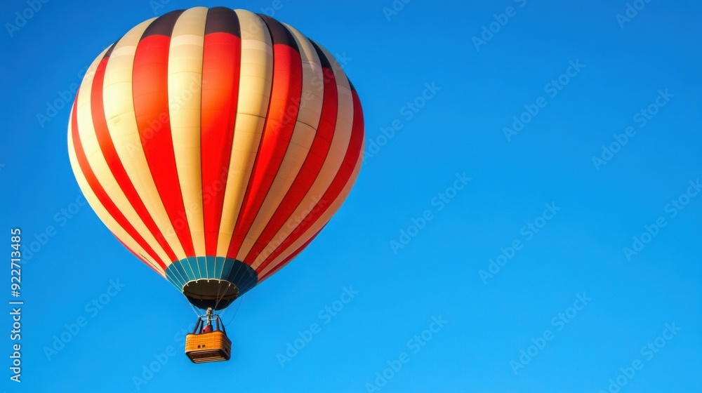 Obraz premium A large hot air balloon flying in the sky with a small box attached, AI