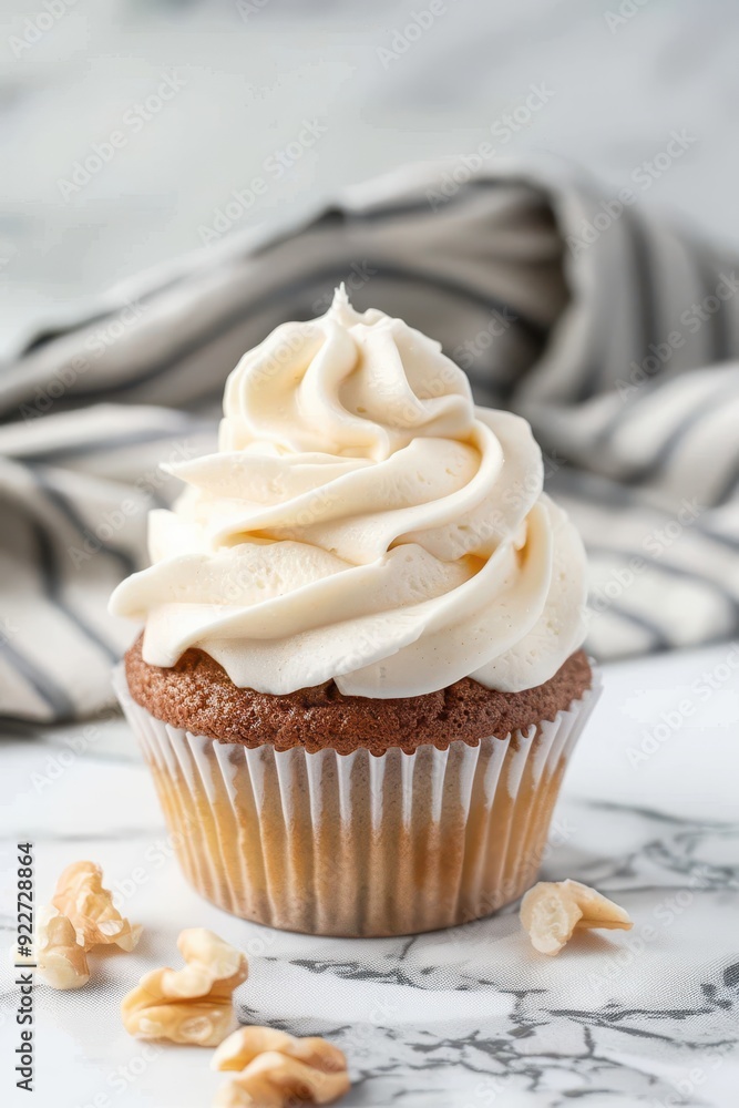 Delicious vanilla cupcake with swirled frosting on a marble countertop. Delicious vanilla cupcake with swirled frosting on a marble countertop.