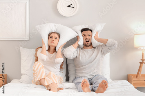 Young couple with pillows s...