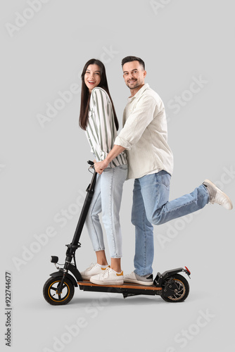 Young couple riding electri...