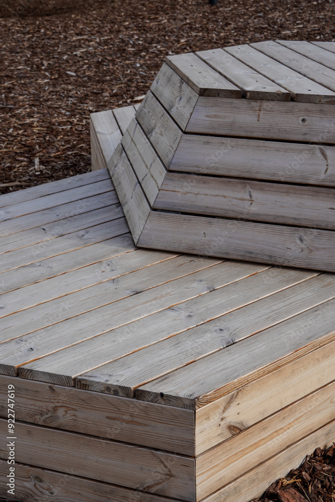 Close up of wood planks construction for sitting. Empty modern wooden bench. Brown ground. Tallinn, Estonia, Europe. July 2024 Close up of wood planks construction for sitting. Empty modern wooden bench. Brown ground. Tallinn, Estonia, Europe. July 2024