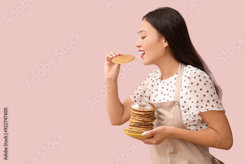 Young Asian woman eating ta...
