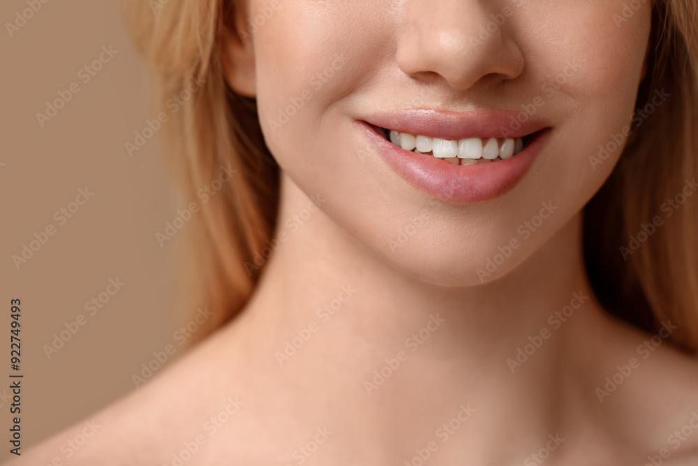 Smiling young woman with beautiful lips on brown background, closeup Smiling young woman with beautiful lips on brown background, closeup
