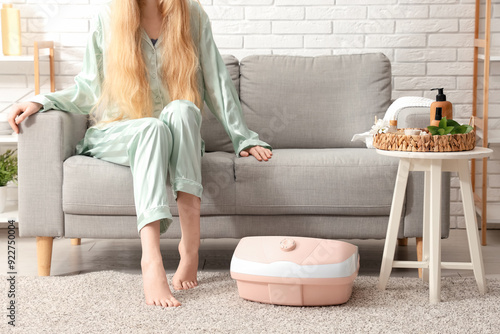 Woman with massage foot bat...
