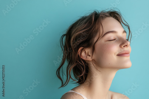 A close up of a woman's face with her eyes closed