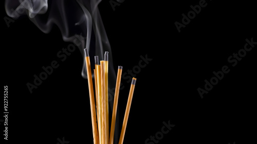 Aromatic incense sticks smoldering on black background. Generative AI photo