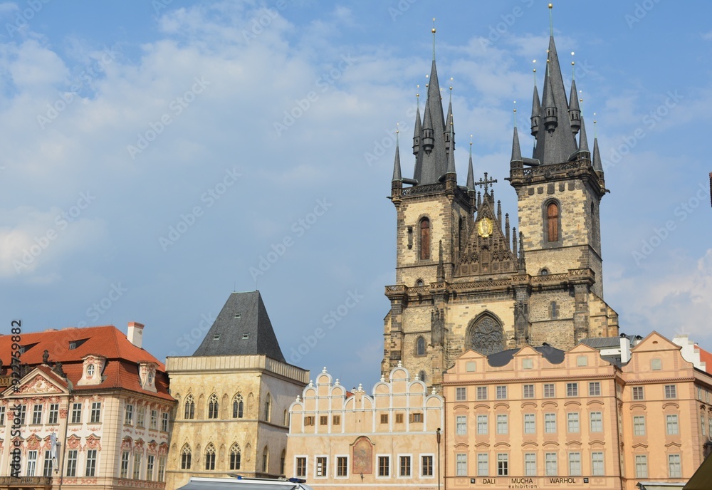 Obraz premium European city with a gothic church and colorful buildings in the old town square.