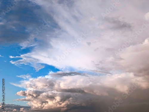 Dramatic skyscape with bright white and grey clouds contrasting against a vibrant blue sky