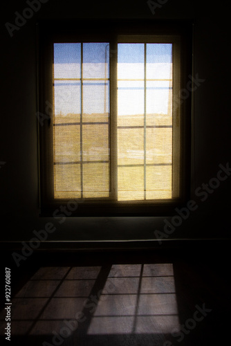 An Image of a Open Window and shadow on ground 