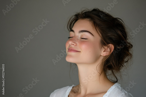 A close up of a woman's face with her eyes closed