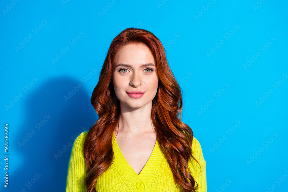 Photo of adorable gorgeous nice girl with ginger wavy hairstyle dressed yellow knit cardigan smiling isolated on blue color background Photo of adorable gorgeous nice girl with ginger wavy hairstyle dressed yellow knit cardigan smiling isolated on blue color background
