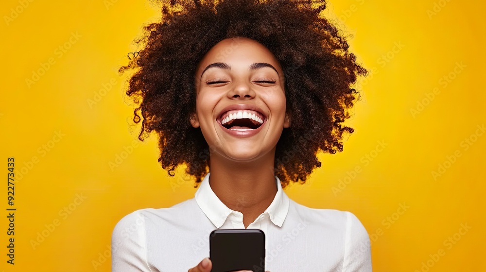 Joyful Woman With Curly Hair Holding Smartphone Against Bright Yellow Background Joyful Woman With Curly Hair Holding Smartphone Against Bright Yellow Background