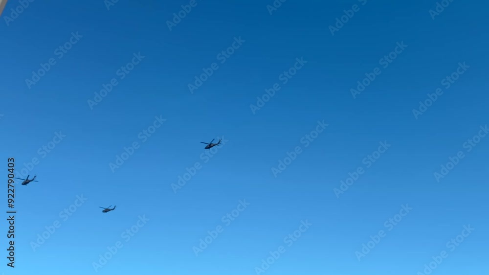 military helicopters flying against a blue sky military helicopters flying against a blue sky