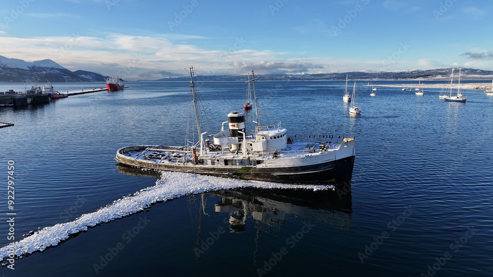 Fototapeta premium Saint Christopher Boat At Ushuaia In Tierra Del Fuego Argentina. Saint Christopher Boat. Ship Sculpture. Downtown Cityscape. Saint Christopher Boat At Ushuaia In Tierra Del Fuego Argentina.