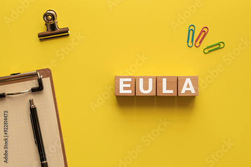 There is wood cube with the word EULA. It is an abbreviation for End User License Agreement as eye-catching image. photo