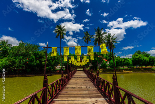 Background of Wat Traphang Thong, which is located in the middle of the water and has a wooden bridge, which is used to organize ceremonies (Loi Krathong, New Year) in Sukhothai province, Thailand. photo