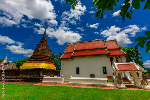 Background of Wat Traphang Thong, which is located in the middle of the water and has a wooden bridge, which is used to organize ceremonies (Loi Krathong, New Year) in Sukhothai province, Thailand. photo