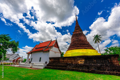 Background of Wat Traphang Thong, which is located in the middle of the water and has a wooden bridge, which is used to organize ceremonies (Loi Krathong, New Year) in Sukhothai province, Thailand. photo