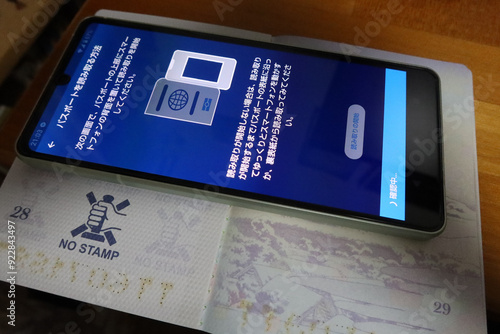 A smartphone with ESTA mobile application screen and a Japanese passport in Tokyo, Japan. August 1, 2024